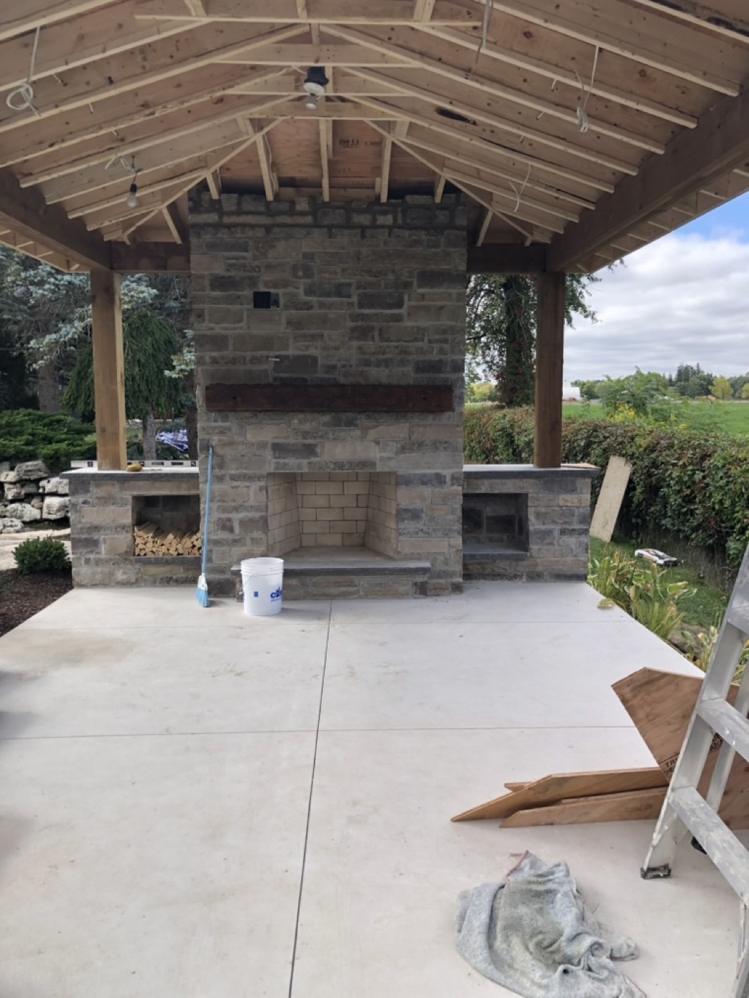 Outdoor stone fireplace and covered patio masonry